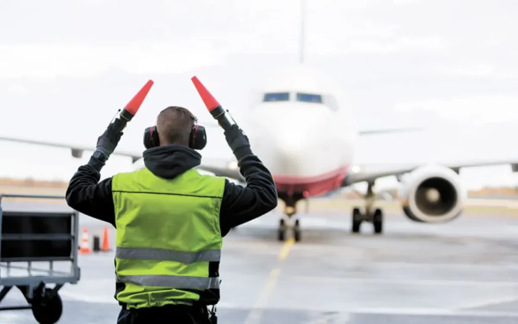 What is the salary of airport ground staff in india? 1 Airport ground staff member doing aircraft marshalling