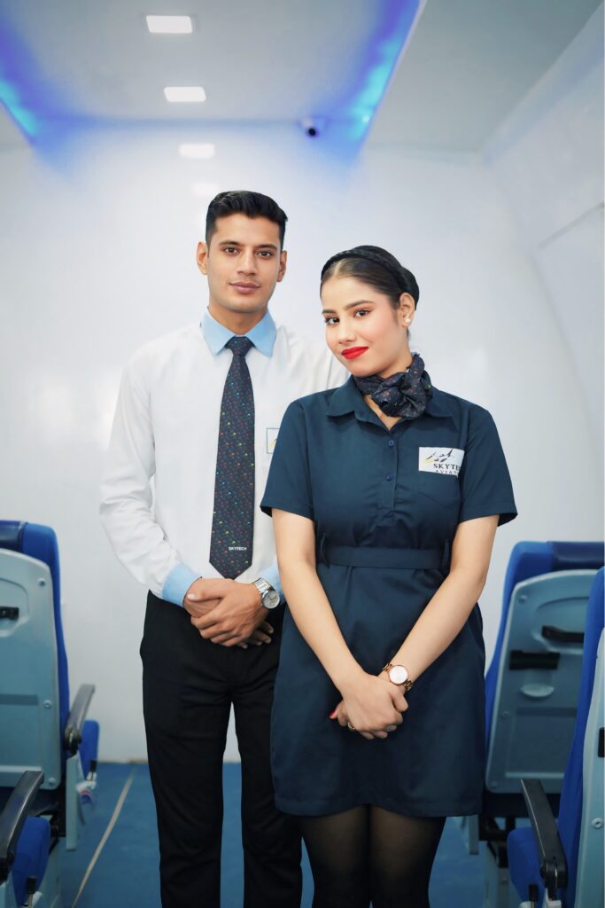 One male cabin crew and one female air hostess is standing together and posing