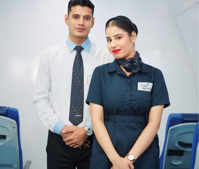 One male cabin crew and one female air hostess is standing together and posing